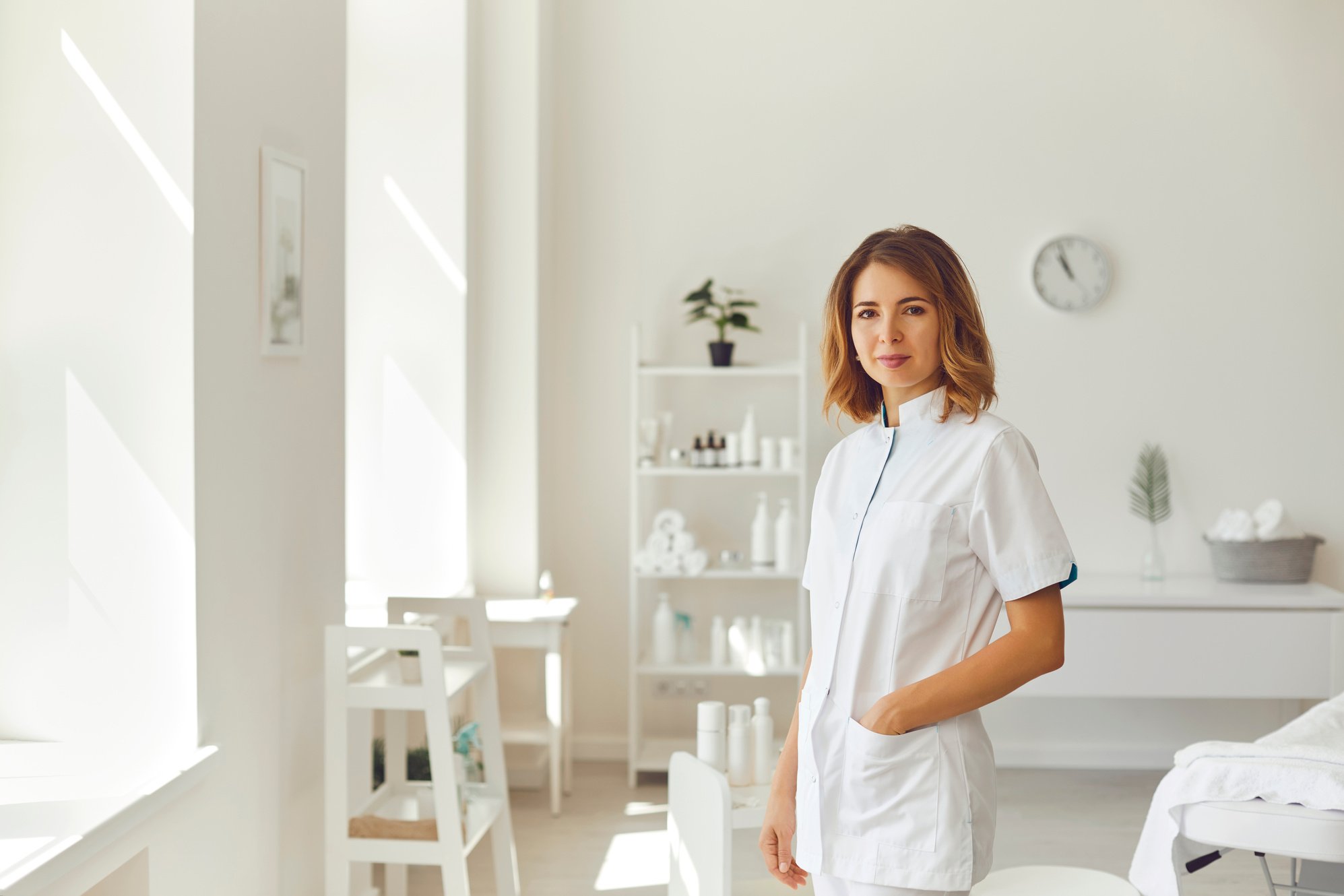 Smiling Woman Cosmetologist or Dermatologist Standing and Looking at Camera in Beauty Spa Salon